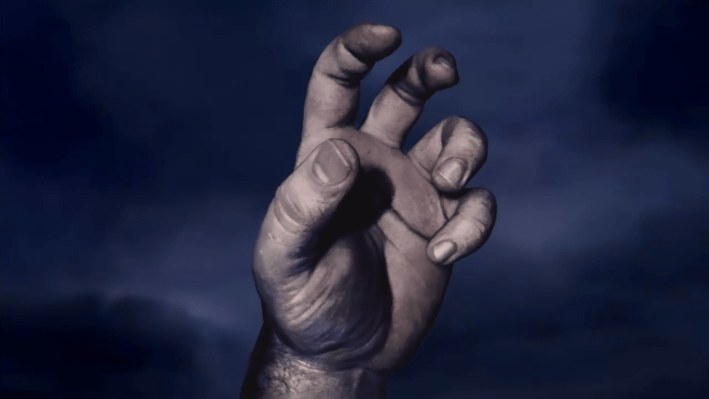 The Game over Screen of Baldur's Gate. A grasping hand against a dark clouded sky.